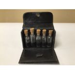 A SMALL BLACK LEATHER CASED SPECIMEN BOTTLES HOLDER 9.5 X 6CM