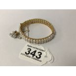 A CONTINENTAL YELLOW METAL AND SEEDED PEARL BRACELET 6CM DIAMETER HAS A SAFETY CHAIN TOTAL WEIGHT 25