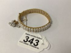 A CONTINENTAL YELLOW METAL AND SEEDED PEARL BRACELET 6CM DIAMETER HAS A SAFETY CHAIN TOTAL WEIGHT 25