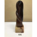 A STYLISED STATUE MADE FROM WOOD ON A ALABASTER BASE MARKED 'BRB' 27CM HIGH