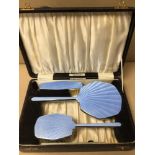 A VINTAGE ENGLISH CASED VANITY SET WITH BLUE GUILLOCHE ENAMEL FITTED ON CHROMIUM PLATED 30CM X 21CM