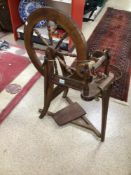 A VINTAGE WOODEN SPINNING WHEEL