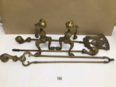 A VINTAGE BRASS BALL AND CLAW MOTIF FIRE COMPANION SET WITH A PAIR OF FIREDOGS TO MATCH