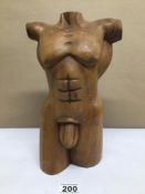 A WOODEN SCULPTURE OF A NUDE MALE TORSO 32CM IN HEIGHT