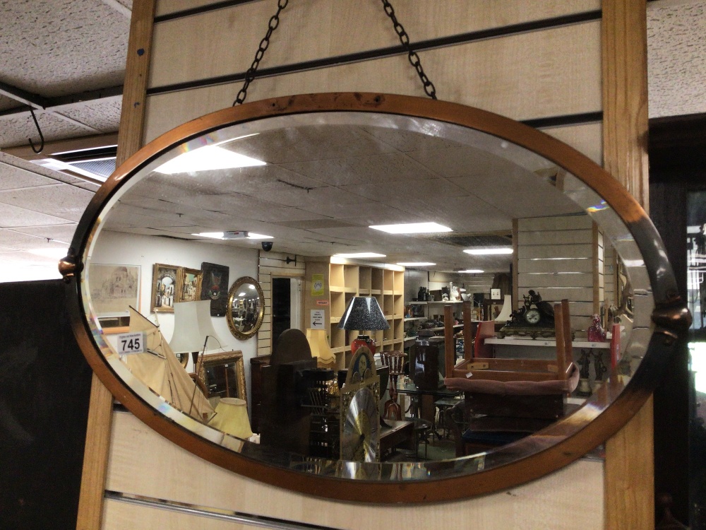 AN ART NOUVEAU OVAL COPPER MIRROR WITH BEVELLED GLASS A/F, 71 X 42CM