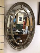 A VINTAGE SILVERED OVAL BEVELLED MIRROR, 78 X 53CM