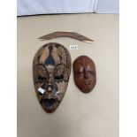 TWO WOODEN TRIBAL WALL MASKS KORURU (NEW ZEALAND) AND ONE OTHER, ALSO A BOOMARANG