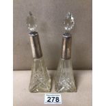 A PAIR OF CUT GLASS PERFUME BOTTLES WITH HALLMARKED SILVER COLLARS (MARKS RUBBED), 18CM