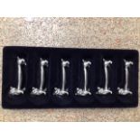 A VINTAGE SET OF SIX WHITE METAL / PLATED CAT KNIFE RESTS