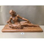 AN ART DECO FIGURE WITH DOG SIGNED BOTH LAYING DOWN, 55 X 29CM