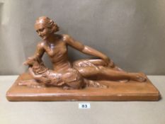 AN ART DECO FIGURE WITH DOG SIGNED BOTH LAYING DOWN, 55 X 29CM