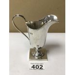 A HALLMARKED SILVER HELMET SHAPED CREAM JUG ON SQUARE PLATFORM BASE, 12CM, 85G