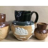 THREE ROYAL DOULTON STONE GLAZED POURING JUGS, THE LARGEST 19CM