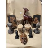 A MIXED COLLECTION OF CARVED WOODEN AFRICAN FIGURES, PORTRAITS, SKIN DRUMS, AND MORE