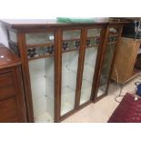 AN ART NOUVEAU BREAKFRONT FLOOR STANDING DISPLAY CABINET WITH FOUR DOORS