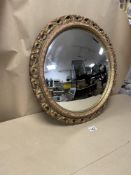 AN OVAL CONVEX MIRROR WITH GILDED BORDERS 50CM IN DIAMETER