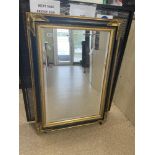 A BLACK AND GILDED BEVELLED MIRROR, 110 X 79CM