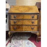 A 1940'S WALNUT BUREAU ON CABRIOLE LEGS