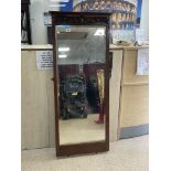 AN ORNATE MAHOGANY FRAMED BEVELLED WALL MIRROR, 146 X 63CM