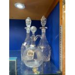 A PAIR OF VICTORIAN TALL CUT GLASS DECANTERS WITH STEEPLE STOPPERS, 37CM WITH VICTORIAN ENGRAVED