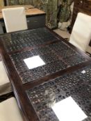 A MODERN MANGO WOODEN DINING TABLE WITH THREE FRETWORK SLOTS WITH GLASS AND SIX MODERN DINING CHAIRS