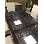 A MODERN MANGO WOODEN DINING TABLE WITH THREE FRETWORK SLOTS WITH GLASS AND SIX MODERN DINING CHAIRS