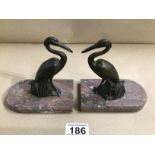 A PAIR OF ART DECO METAL BOOKENDS IN THE FORM OF STORKS ON MARBLE BASES
