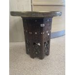 A MIDDLE EASTERN BRASS TOP TABLE WITH THE BASE DECORATED WITH MOTHER OF PEARL