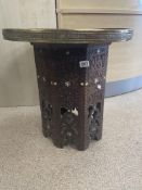 A MIDDLE EASTERN BRASS TOP TABLE WITH THE BASE DECORATED WITH MOTHER OF PEARL