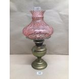 A VINTAGE BRASS OIL LAMP WITH A PINK-TINTED GLASS SHADE, BEING 48CM IN HEIGHT