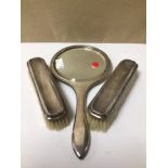 A HALLMARKED SILVER DRESSING TABLE SET OF TWO BRUSHES AND A MIRROR