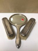 A HALLMARKED SILVER DRESSING TABLE SET OF TWO BRUSHES AND A MIRROR