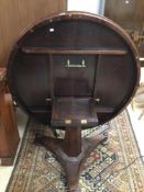 VICTORIAN MAHOGANY ROUND TILT TOP DINING TABLE ON PEDESTAL BASE AND BUNG FEET