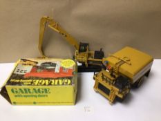 TWO CAT CONSTRUCTION DIE-CAST MODEL VEHICLES WITH A BOXED GARAGE, A KLEIN K-2000 WATER TANK, AND A