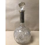 A CUT GLASS DECANTER WITH 925 SILVER CASED NECK 29CM