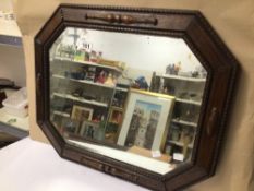AN EARLY 20TH CENTURY ARTS N’ CRAFTS BEVELLED EDGE WALL MIRROR IN OCTAGONAL FORM, WITH A