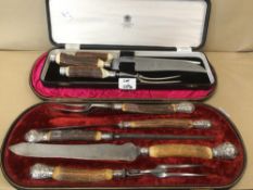TWO CASED HORN HANDLED CARVING SETS, ONE SET IS HALLMARKED SILVER ON COLLAR AND POMMEL