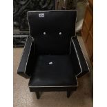 A SMALL CHILDS RETRO/MID-CENTURY ARMCHAIR IN BLACK WITH WHITE PIPEING