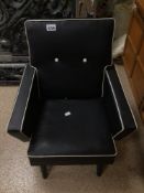 A SMALL CHILDS RETRO/MID-CENTURY ARMCHAIR IN BLACK WITH WHITE PIPEING