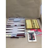 A TRAVEL/FOLDING THIRTY-TWO PIECE CHESS SET AND GUIDE WITH A TRAVEL CARRYING CASE BACKGAMMON SET AND