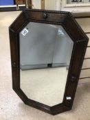 AN EARLY 20TH CENTURY ARTS N’ CRAFTS BEVELLED EDGE WALL MIRROR IN OCTAGONAL FORM, WITH A