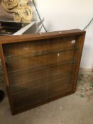 A MODERN OAK DISPLAY WALL CABINET WITH INTERNAL GLASS SHELVES AND SLIDING GLASS DOORS 76 X 12 X