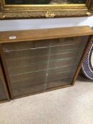 A WOODEN DISPLAY CABINET WITH GLASS SHELVES AND GLASS SLIDING DOORS 76 X 76 X 12CM