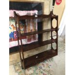 AN ANTIQUE MAHOGANY WALL RACK WITH FOUR SHELVES WITH THREE BOTTOM DRAWERS