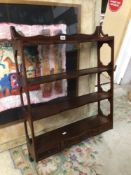 AN ANTIQUE MAHOGANY WALL RACK WITH FOUR SHELVES WITH THREE BOTTOM DRAWERS