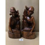 A PAIR OF PITA MAHA STYLED BALINESE CARVED WOODEN FIGURES/BOOKENDS