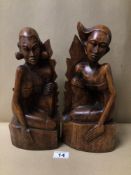 A PAIR OF PITA MAHA STYLED BALINESE CARVED WOODEN FIGURES/BOOKENDS