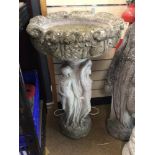 A LARGE CONCRETE BIRD BATH ON PEDESTAL BASE DECORATED WITH LADIES, 87CM HIGH