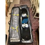 A SALOMON SNOWBOARD WITH CARRY CASE