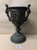 A VICTORIAN METAL URN DECORATED WITH CHERUBS, 35CM